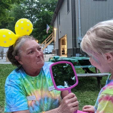 face painting woman with child