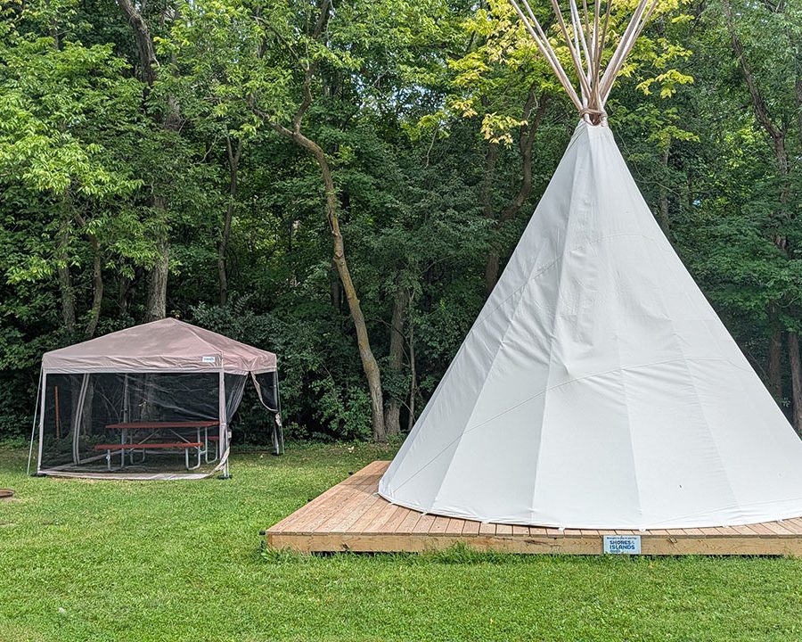 Tipi rental with screened picnic area at Crystal Rock Campground in Sandusky, Ohio
